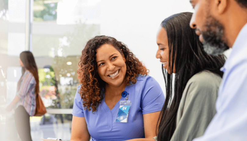 Value of the DCES in Inpatient Care Adult female medical professional explaining medical chart to adult couple